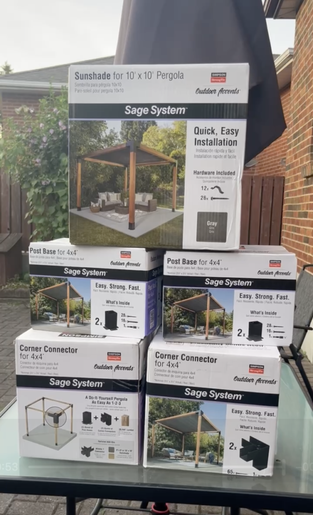 Simpson Strong-Tie Sage System pergola connectors and hardware laid out before assembly.